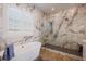 Bright and airy bathroom with marble accents, soaking tub, and glass shower at 654 Jungle Queen Way, Longboat Key, FL 34228