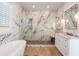 Stunning bathroom featuring marble walls, glass enclosed shower, and soaking tub at 654 Jungle Queen Way, Longboat Key, FL 34228
