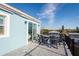 Rooftop deck with outdoor furniture and views, with a blue exterior and sliding glass doors to the interior at 654 Jungle Queen Way, Longboat Key, FL 34228
