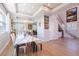 Open-concept living room and dining area showcasing tray ceilings, chandelier, staircase and bar at 654 Jungle Queen Way, Longboat Key, FL 34228