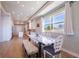 Dining area with a large window offering beautiful water views, and an open connection to the modern kitchen at 654 Jungle Queen Way, Longboat Key, FL 34228