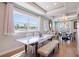 Dining room featuring tray ceilings, wood-look flooring, large window, and elegant furnishings at 654 Jungle Queen Way, Longboat Key, FL 34228