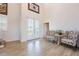 Light and airy foyer with soaring ceilings, wood-look tile flooring, and decorative furnishings at 654 Jungle Queen Way, Longboat Key, FL 34228