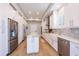 Well-lit kitchen with custom cabinets, stainless appliances, and a center island for meal prep at 654 Jungle Queen Way, Longboat Key, FL 34228