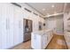 Bright kitchen with abundant storage, stainless steel refrigerator, and a functional center island at 654 Jungle Queen Way, Longboat Key, FL 34228