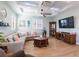 Inviting living room featuring stylish furniture, wood floors, and a modern ceiling fan at 654 Jungle Queen Way, Longboat Key, FL 34228