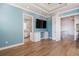 Spacious living room with TV, wood look flooring, and ensuite bathroom access at 654 Jungle Queen Way, Longboat Key, FL 34228