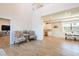Open-concept living room showcasing soaring ceilings, wood-look tile flooring, and open access to the dining room at 654 Jungle Queen Way, Longboat Key, FL 34228