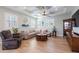 Spacious living room with comfortable seating, a ceiling fan, and plenty of natural light at 654 Jungle Queen Way, Longboat Key, FL 34228