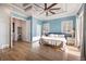 Light-filled main bedroom features tray ceiling, ceiling fan, and ensuite bathroom at 654 Jungle Queen Way, Longboat Key, FL 34228