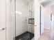 Modern shower showcasing marble-look tile and black hexagonal floor tile at 654 Jungle Queen Way, Longboat Key, FL 34228