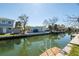 Picturesque waterfront property with lush foliage and clear canal views, featuring boat dockage at 654 Jungle Queen Way, Longboat Key, FL 34228