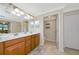 Bathroom with dual sinks, a vanity, and a separate toilet room for added privacy at 6914 Grand Estuary Trl # 101, Bradenton, FL 34212
