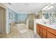 Well-appointed bathroom featuring a soaking tub, walk-in shower, and dual vanities at 6914 Grand Estuary Trl # 101, Bradenton, FL 34212