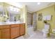 Bright bathroom with double sinks, vanity, and shower-tub combination at 6914 Grand Estuary Trl # 101, Bradenton, FL 34212