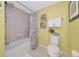 Well-lit bathroom features shower-tub and tropical art accents at 6914 Grand Estuary Trl # 101, Bradenton, FL 34212