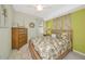 Comfortable bedroom with palm themed decor, dresser, and ceiling fan at 6914 Grand Estuary Trl # 101, Bradenton, FL 34212