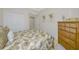 Comfortable bedroom with palm themed decor, dresser, and closet at 6914 Grand Estuary Trl # 101, Bradenton, FL 34212
