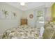 Bright bedroom with palm themed decor, dresser, and ceiling fan at 6914 Grand Estuary Trl # 101, Bradenton, FL 34212