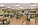 Spacious clubhouse lounge area with tables, chairs, and large windows overlooking the community at 6914 Grand Estuary Trl # 101, Bradenton, FL 34212