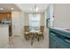 Bright dining area featuring a glass table, wicker chairs, and plenty of natural light at 6914 Grand Estuary Trl # 101, Bradenton, FL 34212