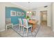 Charming dining room featuring a wooden table, neutral chairs, and colorful accent wall at 6914 Grand Estuary Trl # 101, Bradenton, FL 34212