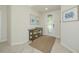 Bright foyer featuring neutral tile floors, decorative console table, and glass front door at 6914 Grand Estuary Trl # 101, Bradenton, FL 34212