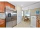 Kitchen with stainless steel fridge and adjacent dining area at 6914 Grand Estuary Trl # 101, Bradenton, FL 34212