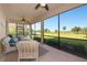 Comfortable screened lanai boasts golf course views, ceiling fan, and seating at 6914 Grand Estuary Trl # 101, Bradenton, FL 34212