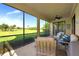 Picturesque screened lanai with comfortable seating and expansive views of the lush green golf course and serene surroundings at 6914 Grand Estuary Trl # 101, Bradenton, FL 34212