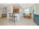 Open concept living space featuring bar seating, small dining area, and views of the kitchen at 6914 Grand Estuary Trl # 101, Bradenton, FL 34212