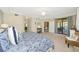 Bright main bedroom featuring a king bed, slider door access to balcony, and coastal accents at 6914 Grand Estuary Trl # 101, Bradenton, FL 34212