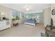 Spacious main bedroom with a king-sized bed, coastal decor, and a ceiling fan at 6914 Grand Estuary Trl # 101, Bradenton, FL 34212