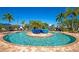 Serene outdoor pool area surrounded by cozy lounge seating and lush landscaping at 6914 Grand Estuary Trl # 101, Bradenton, FL 34212
