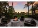 Backyard view of a fire pit with seating area overlooking a lake and golf course at 7218 Teal Creek Gln, Lakewood Ranch, FL 34202