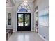 Grand foyer with a chandelier, decorative art, high ceilings, and a view through double front doors at 7218 Teal Creek Gln, Lakewood Ranch, FL 34202