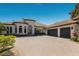 Beautiful single-story home boasts a circular driveway with lush landscaping and a three-car garage at 7218 Teal Creek Gln, Lakewood Ranch, FL 34202