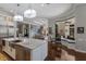 Open-concept kitchen showcasing stainless steel appliances, a marble island, and views into the adjoining rooms at 7218 Teal Creek Gln, Lakewood Ranch, FL 34202