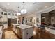 Bright, open kitchen showcasing a large island, stainless steel appliances, and modern lighting fixtures at 7218 Teal Creek Gln, Lakewood Ranch, FL 34202