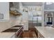 Well-equipped kitchen with a professional-grade range, stainless steel refrigerator, and marble countertops at 7218 Teal Creek Gln, Lakewood Ranch, FL 34202