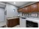 Functional laundry room with ample storage, countertop space, and modern appliances at 7218 Teal Creek Gln, Lakewood Ranch, FL 34202