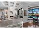 Cozy living room with a fireplace, modern lighting, stylish furniture, and views to the pool area at 7128 Teal Creek Gln, Lakewood Ranch, FL 34202