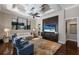 Comfortable living room with custom millwork, modern furnishings, and a large flat-screen television at 7218 Teal Creek Gln, Lakewood Ranch, FL 34202