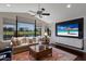 Bright living room featuring large windows overlooking a golf course and a comfortable seating area at 7218 Teal Creek Gln, Lakewood Ranch, FL 34202