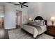 A carpeted bedroom features dark hardwood floors and a luxurious upholstered king-size bed at 7218 Teal Creek Gln, Lakewood Ranch, FL 34202