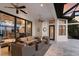 Spacious outdoor patio with comfortable seating, ceiling fans, and beautiful sunset views at 7218 Teal Creek Gln, Lakewood Ranch, FL 34202