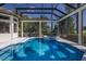 Covered pool with adjoined spa in lush green backyard at 7218 Teal Creek Gln, Lakewood Ranch, FL 34202