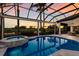 Beautiful screened-in pool and spa with a view of the golf course at sunset at 7218 Teal Creek Gln, Lakewood Ranch, FL 34202