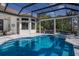 Enclosed swimming pool and spa in outdoor living space with lush landscaping at 7218 Teal Creek Gln, Lakewood Ranch, FL 34202