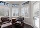 A sun-drenched seating area showcases window shutters and leather armchairs at 7128 Teal Creek Gln, Lakewood Ranch, FL 34202